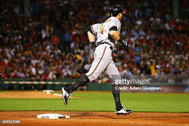 Nolan Reimold of the Baltimore Orioles rounds the bases after hitting a two-run home run in the second inning of a game against the Boston Red Sox at...