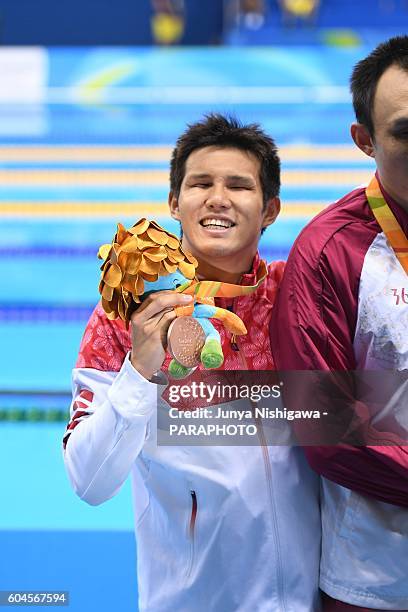 Bronze medalist KIMURA Keiichi of JAPAN celebrates on the podium at the medal ceremony for the Men's 100m Breaststroke - SB11 Final on day 6 of the...