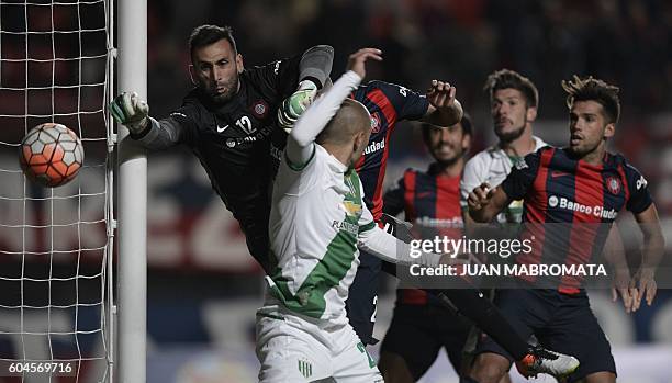 Argentina's San Lorenzo goalkeeper Sebastian Torrico vies for the ball with Argentina's Banfield defender Gonzalo Prosperi during their Copa...
