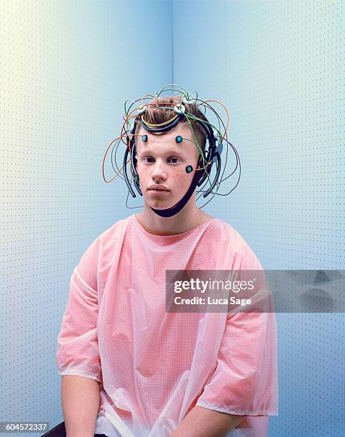 portrait of teenage boy with brain test cap - eeg stock-fotos und bilder