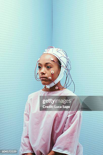 girl with cap of sensors to measure brain activity - eeg stock-fotos und bilder