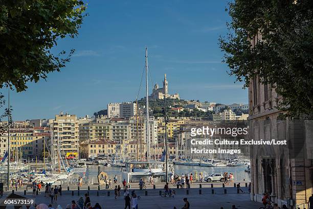 boats in marina, vieux-port, notre dame de la garde in background, marseille, france - vieux port stock pictures, royalty-free photos & images