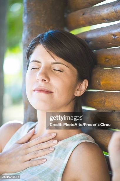 woman relaxing with eyes closed - hands on chest stock pictures, royalty-free photos & images