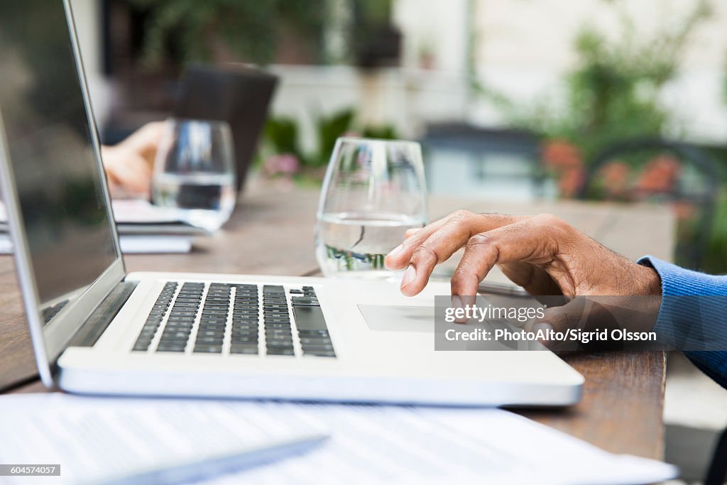 Man using laptop computer touchpad