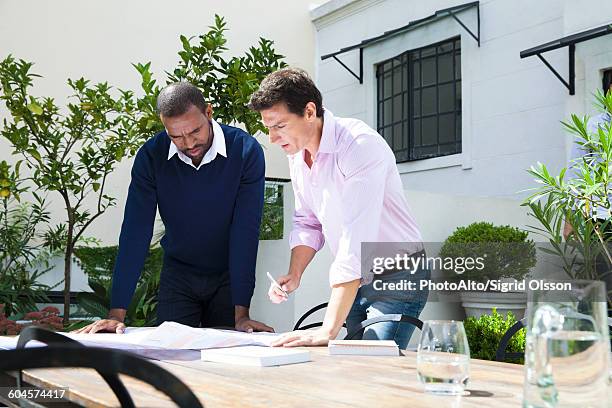 businessmen discussing blueprint - planalto stock pictures, royalty-free photos & images