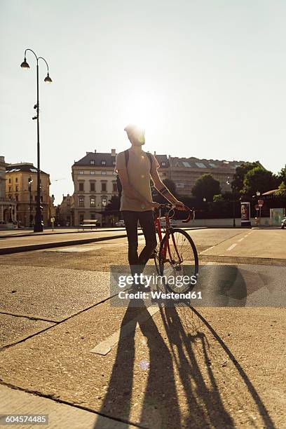 young man with racing cycle in vienna, bicycle lane, dr.-karl-renner-ring - bicycle lane stock-fotos und bilder