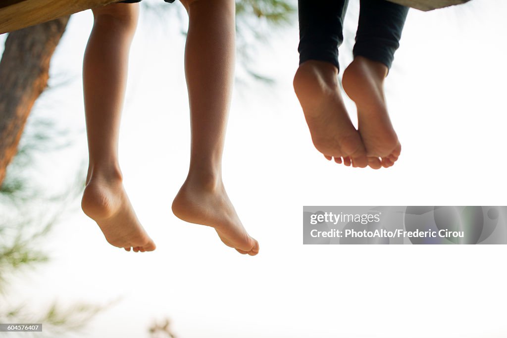 Barefoot children sitting side by side