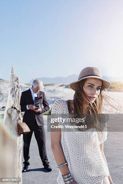 south africa, cape town, portrait of young model with photographer in the background - blue white summer hat background stock pictures, royalty-free photos & images