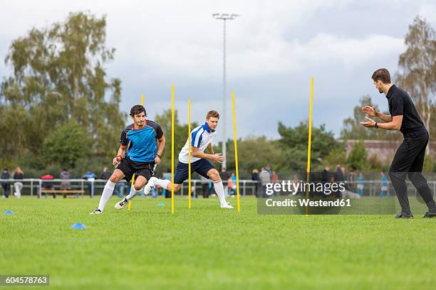 coach exercising with soccer players on sports field - football training stockfoto's en -beelden