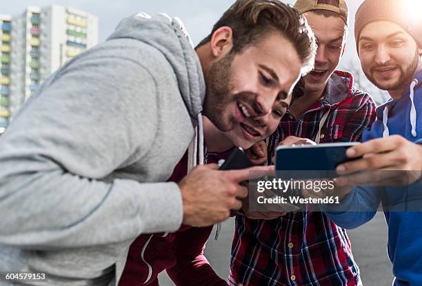 young men with smartphone - cell mates stock-fotos und bilder