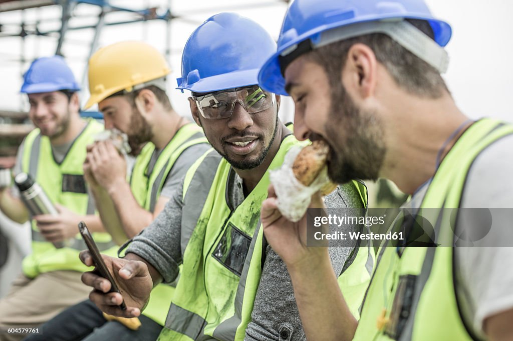 Construction workers having lunch break on construction site