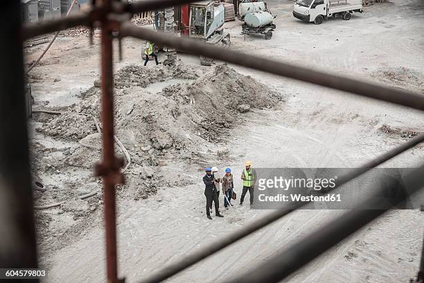 construction worker and executives talking on construction site - person in suit construction stock pictures, royalty-free photos & images