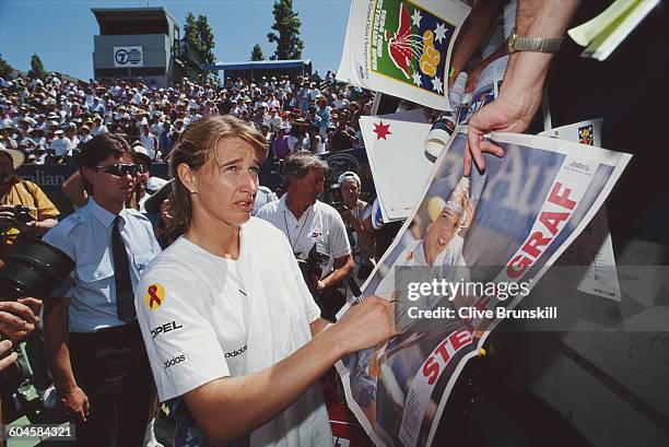 Steffi Graf of Germany signing autographs for her fans during a Women's Singles match at the Australian Open on 17 January 1994 in Flinders Park,...