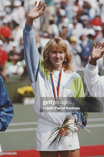 Steffi Graf of Germany celebrates with the gold medal after winning her Women's Singles Final match against Gabriela Sabatini on 30 September 1988...