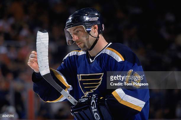 Center Ray Ferraro of the St. Louis Blues examines his hockey stick, during the NHL game against the Detroit Red Wings at the Joe Louis Arena in...