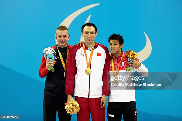 Silver medalist Tharon Drake of the Unites States, gold medalist Bozun Yang of China and bronze medalist Keiichi Kimura of Japan celebrate on the...