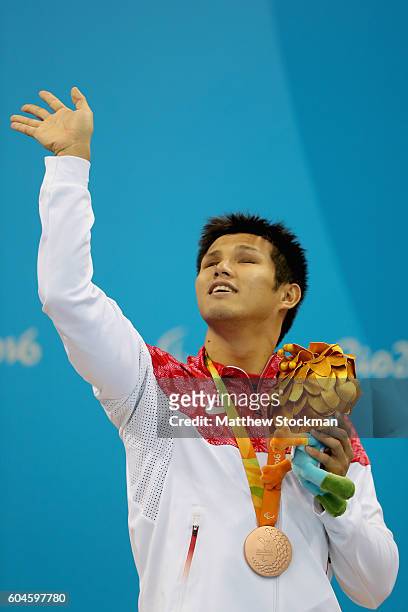 Bronze medalist Keiichi Kimura of Japan celebrates on the podium at the medal ceremony for the Mens 100m Breaststroke SB11 Final during day 6 of the...