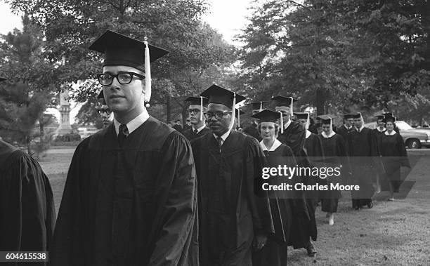 American Civil Rights activist and James Meredith walks with his University of Mississippi classmates during the school's graduation ceremony,...