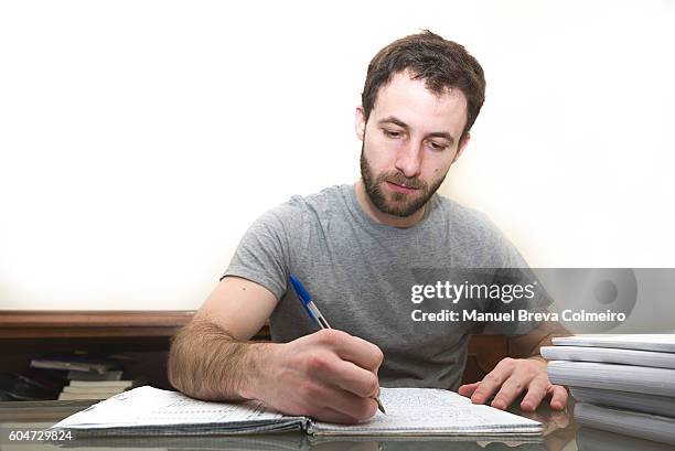 young man taking notes - man writing a letter stock pictures, royalty-free photos & images