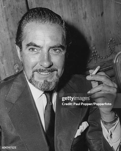 Portrait of American actor Tyrone Power smoking a cigarette in London in August 1958.