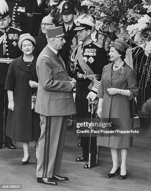 Queen Elizabeth II talks with President Charles de Gaulle of France, with Prince Philip, Duke of Edinburgh and Yvonne de Gaulle on left as the French...