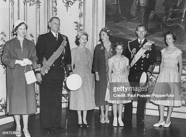 Queen Elizabeth II and Prince Philip, Duke of Edinburgh pose for a portrait with the Danish Royal family; Princess Margrethe, King Frederick IX of...
