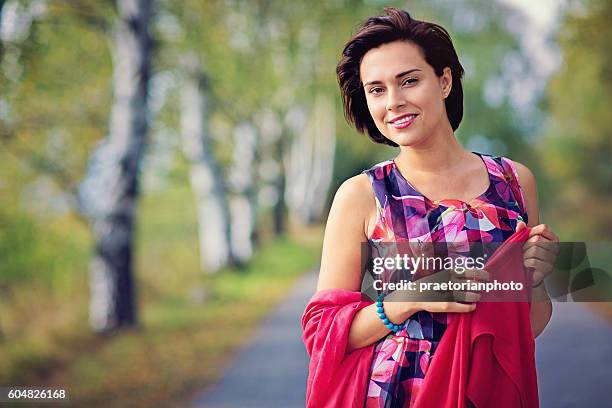 portrait of a beautiful woman in the autumn forest - mature female models stock pictures, royalty-free photos & images