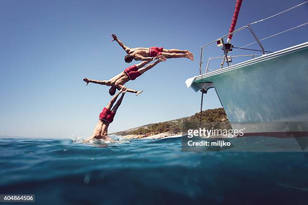diving into the sea from yacht sequence shoot - regular man stock pictures, royalty-free photos & images