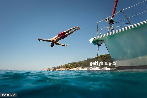 diving into the sea from yacht - diving into water stock pictures, royalty-free photos & images