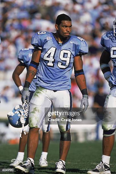 Defensive End Julius Peppers of the North Carolina Tar Heels holding hishelmet while standing on the field during the game against the Wake Forest...