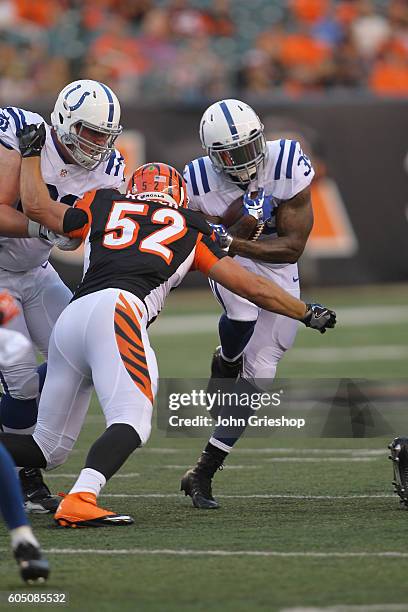 Stevan Ridley of the Indianapolis Colts runs the football upfield against Trevor Roach of the Cincinnati Bengals at Paul Brown Stadium on September...