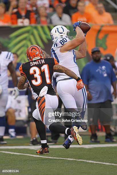 Chase Coffman of the Indianapolis Colts makes the catch in front of Derron Smith of the Cincinnati Bengals at Paul Brown Stadium on September 1, 2016...