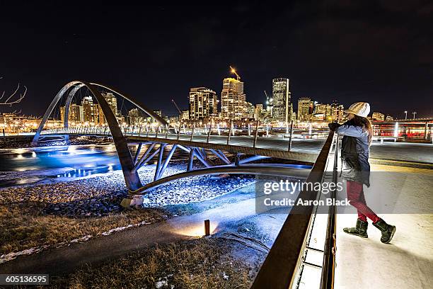 women standing on impressive city bridge - calgary bridge stock pictures, royalty-free photos & images