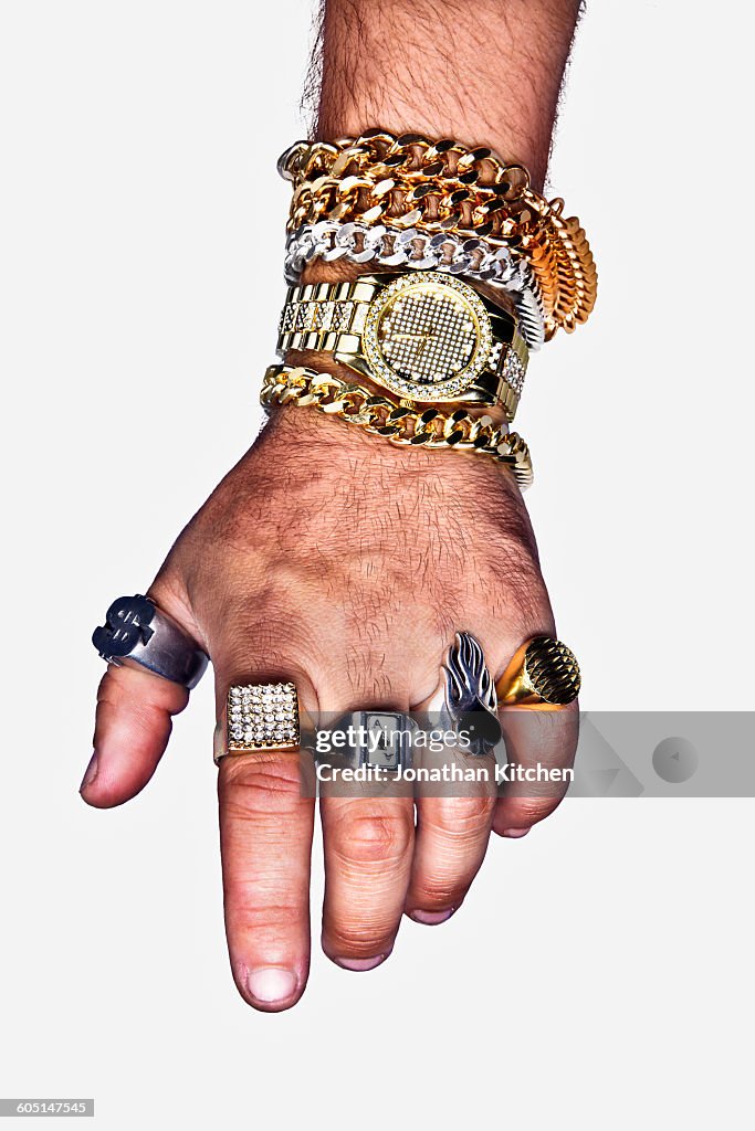 A hand with excess jewellery