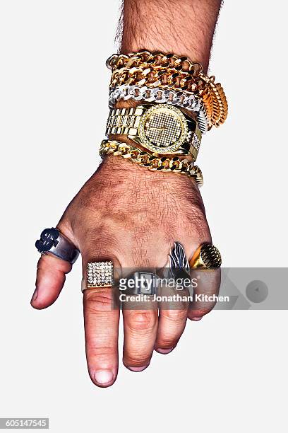 a hand with excess jewellery - guldkedja bildbanksfoton och bilder
