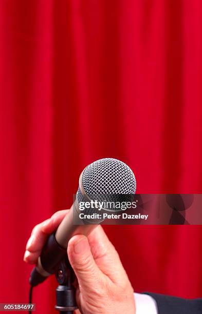 compares hand on microphone upright - compere stock pictures, royalty-free photos & images