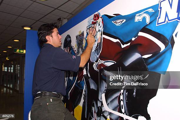 Toronto-based artist David Arrigo paints a mural in the concourse to commemorate the Colorado Avalanche's participation in the 2001 NHL Challenge...