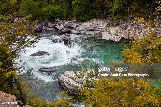 small waterfall, glacier national park - mcdonald creek stock-fotos und bilder