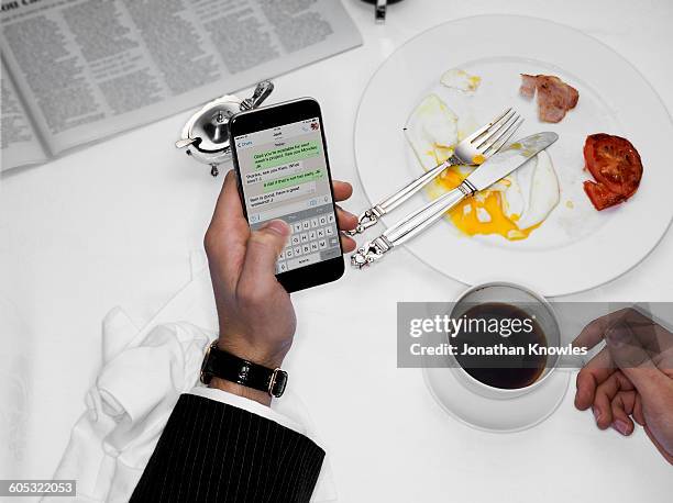 male texting over finished breakfast - social grace stock pictures, royalty-free photos & images