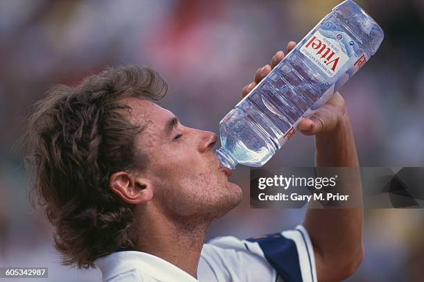 Mats Wilander of Sweden takes a drink during his Men's Singles First Round match against Andre Agassi at the French Open Tennis Championship on 23...