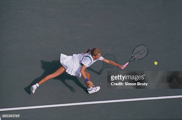 Monica Seles of Yugoslavia reaches to make a return against Chris Evert during their Women's Singles Fourth Round match of the US Open Tennis...