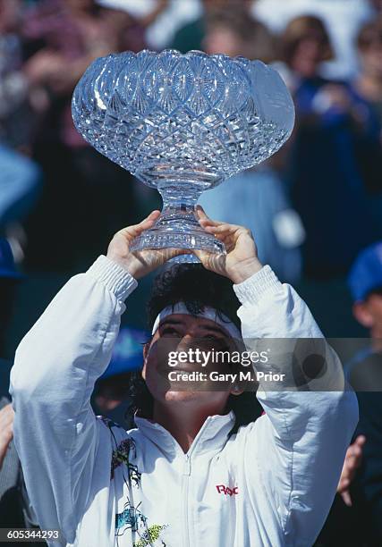 Arantxa Sanchez Vicario of Spain lifts the crystal glass trophy after winning her Women's Singles Final match against Steffi Graf at the ATP Lipton...