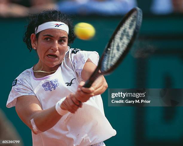 Arantxa Sanchez Vicario of Spain makes a double hand return during the Women's Singles Final match against Steffi Graf at the French Open Tennis...