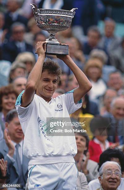 Mats Wilander of Sweden holds aloft the trophy after winning the Men's Singles Final match against Henri Leconte at the French Open Tennis...