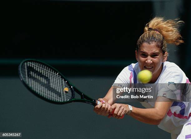 Monica Seles of Yugoslavia makes a double back hand return against Zina Garrison during their Women's Singles Quarter Final match at the Wimbledon...