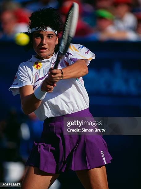 Arantxa Sanchez Vicario of Spain makes a double back hand return against Monica Seles during the Women's Singles final of the US Open Tennis...