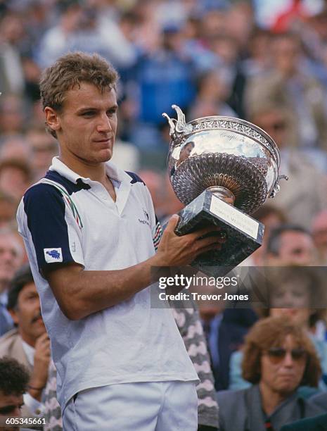 Mats Wilander of Sweden holds aloft the trophy after winning the Men's Singles Final match against Ivan Lendl at the French Open Tennis Championship...