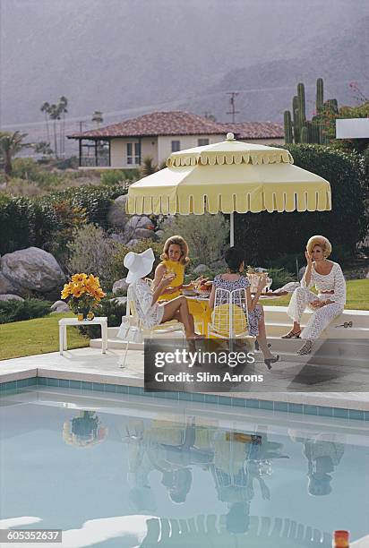 Ladies by the pool at the Kaufmann Desert House in Palm Springs, California, January 1970. From right to left, former fashion model Helen Dzo Dzo...