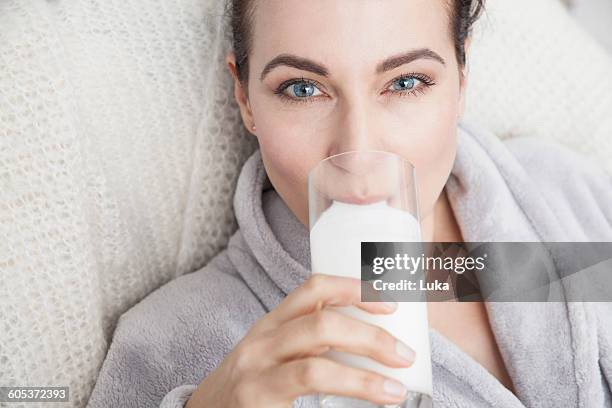 mature drinking a glass of milk - woman drinking milk stock pictures, royalty-free photos & images