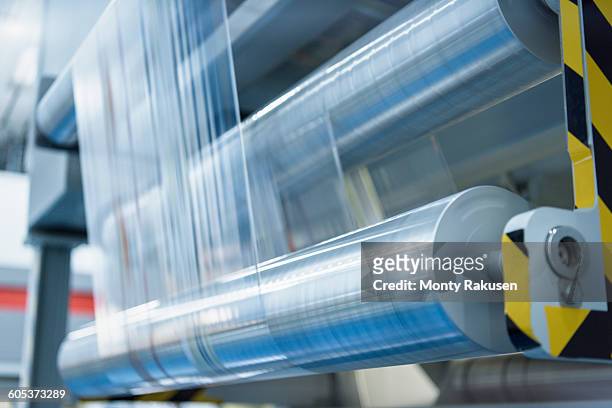 rolls of printed plastic film in food packaging printing factory - plastic stock pictures, royalty-free photos & images